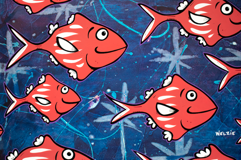 Repeating pattern of red and purple fish on a navy background — aluminum reproduction by Maui artist Welzie