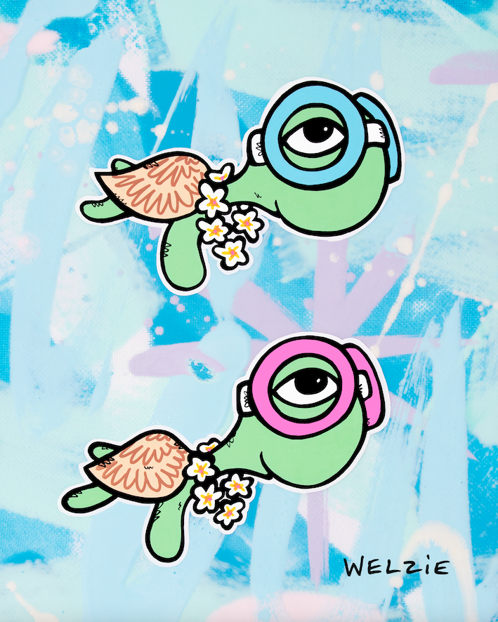 Two green turtle characters wearing pink and blue snorkel masks — aluminum reproduction by Maui artist Welzie