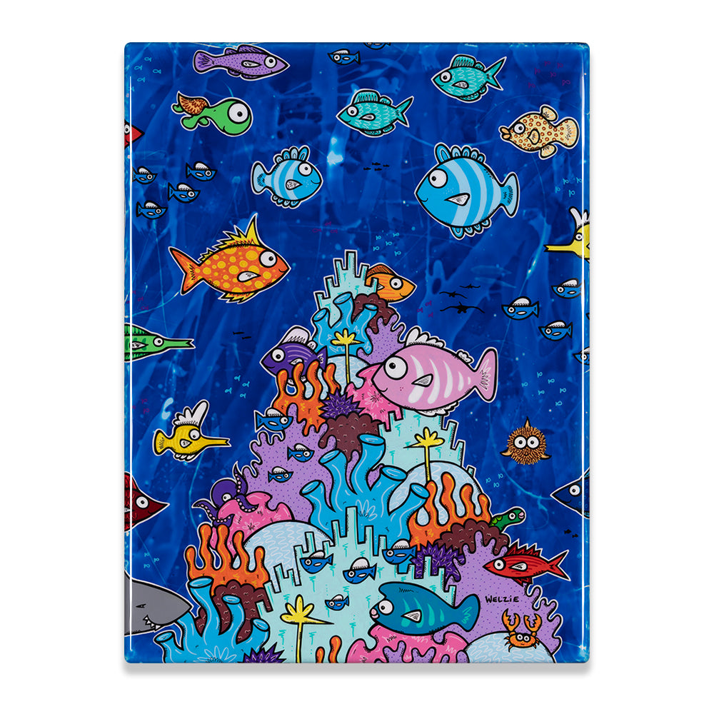 A rectangular glass or acrylic art print featuring a colorful cartoon underwater scene with fish, coral, and sea life on a blue background, photographed against a plain white backdrop.