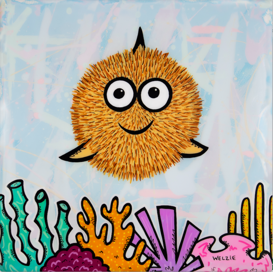 A round pufferfish character with big expressive eyes — aluminum reproduction by Maui artist Welzie