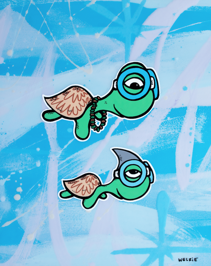Two green turtle characters wearing snorkel masks — aluminum reproduction by Maui artist Welzie