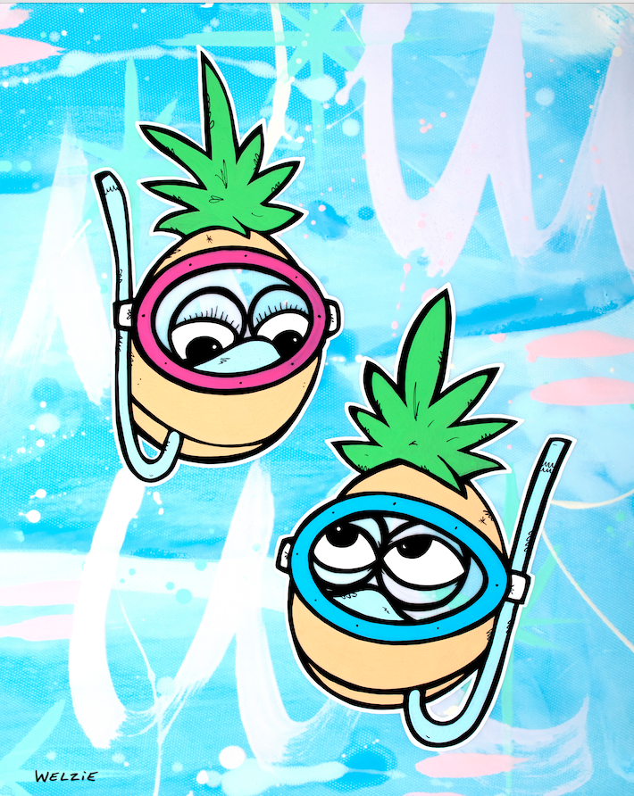 Two pineapple characters wearing snorkel masks side by side — aluminum reproduction by Maui artist Welzie